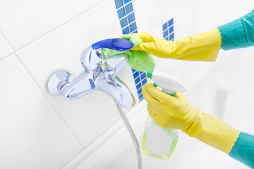 Kitchen surfaces being cleaned during domestic cleaning in Merton